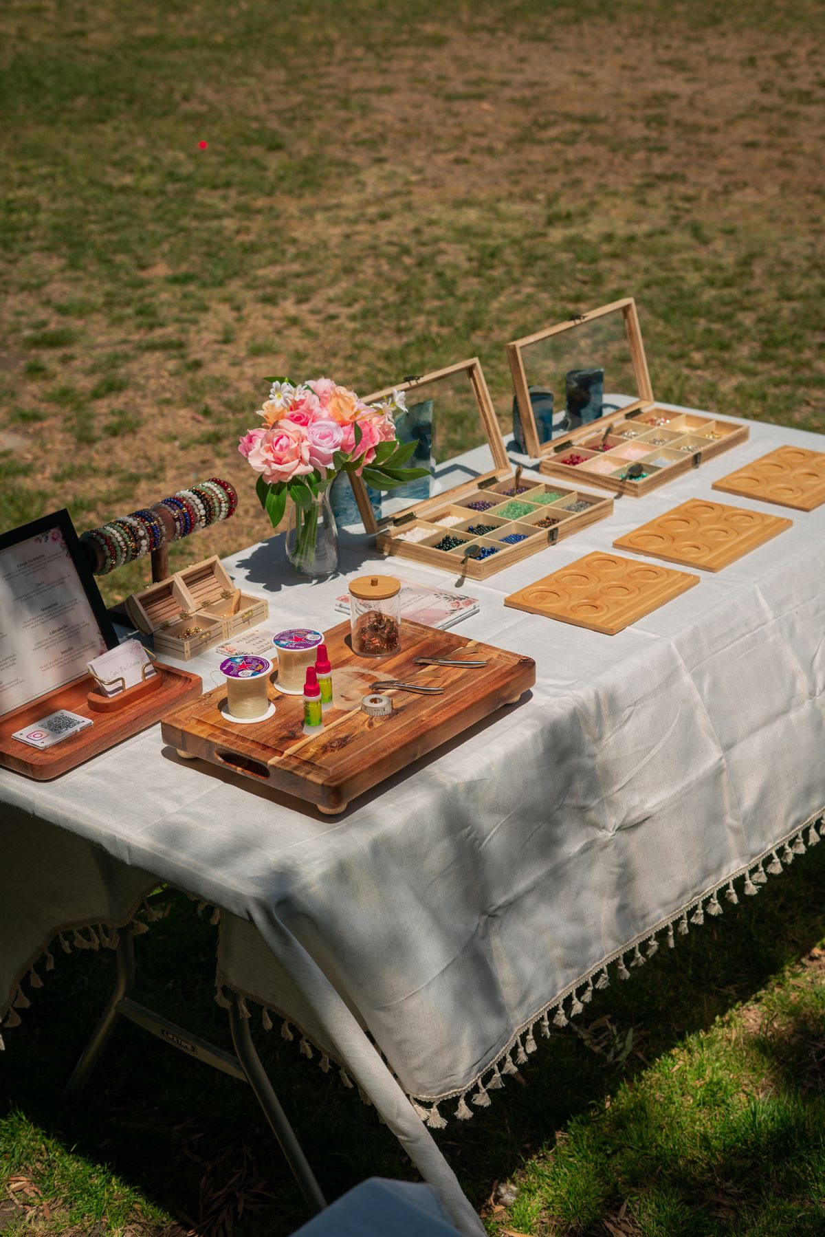 The Stack Sessions bead table set up on the grass with flowers and crystal trays