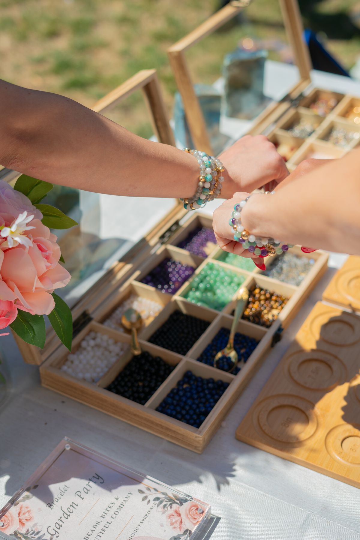Hands over a crystal bead tray at The Stack Sessions