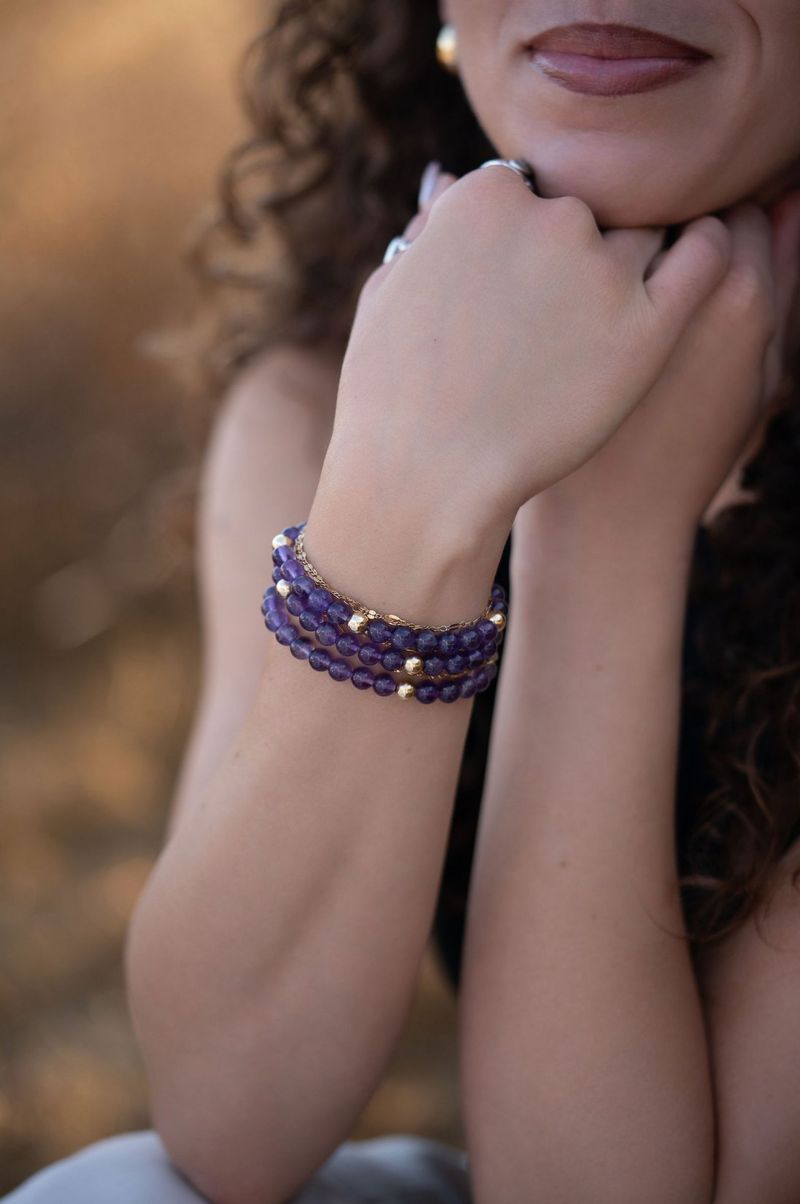 Amethyst bracelet stacked on a wrist