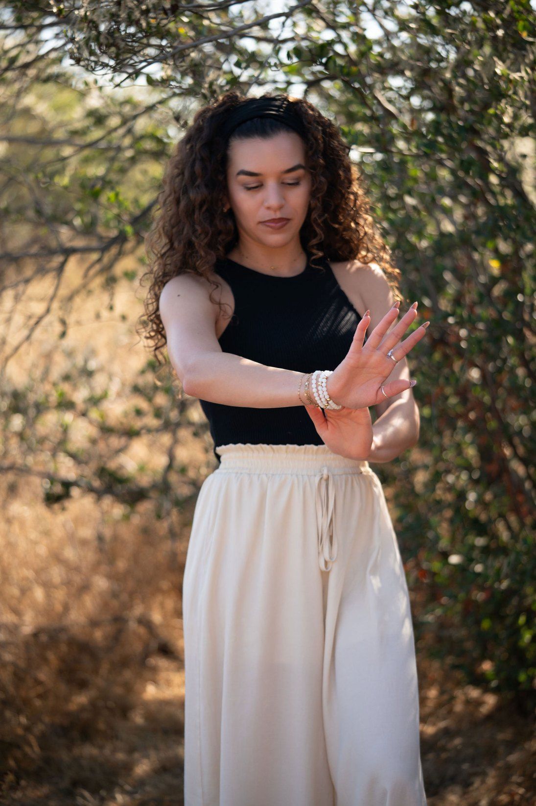 Char-Leen reaching out her hands, wearing a moonstone stack